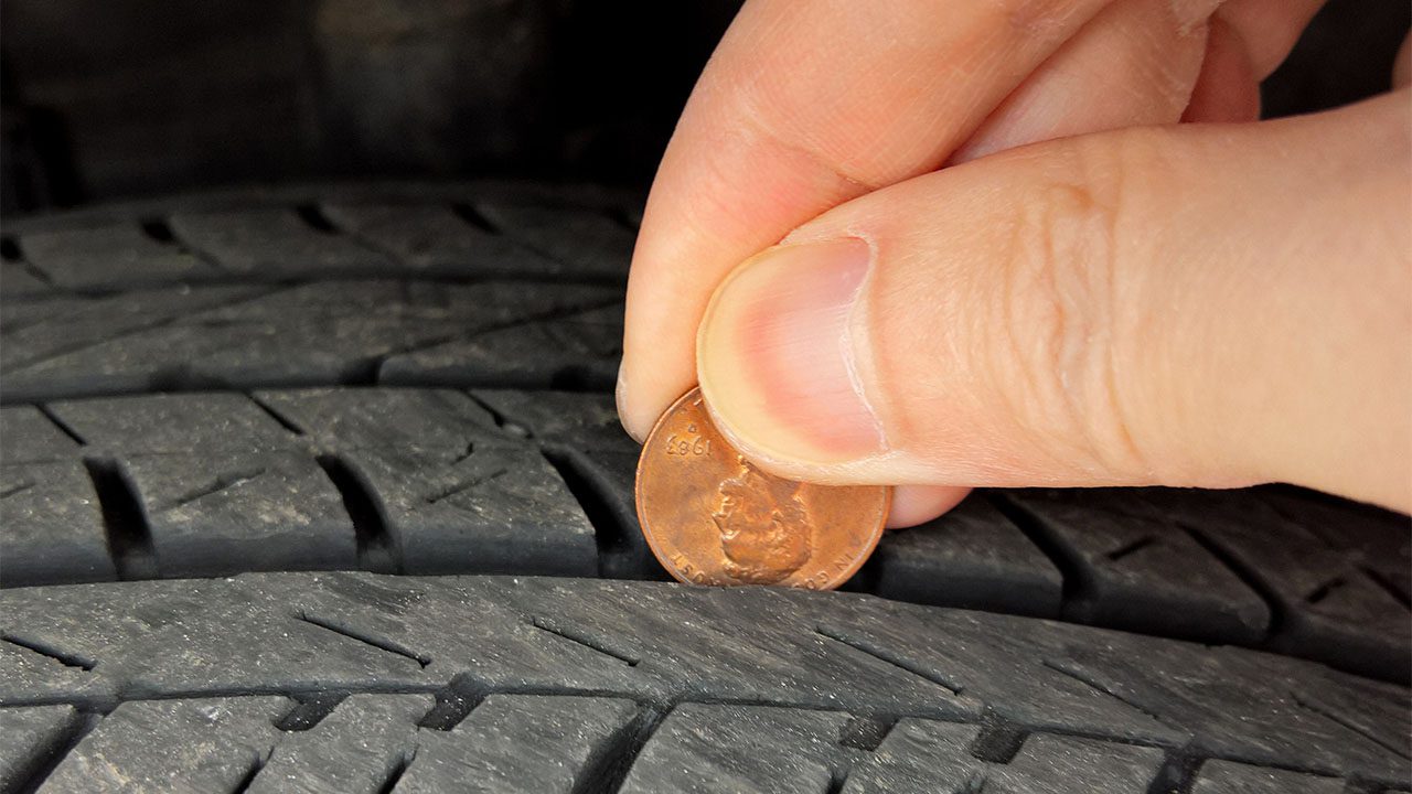 checking tire tread depth and wear with a penny on lincoln's hea