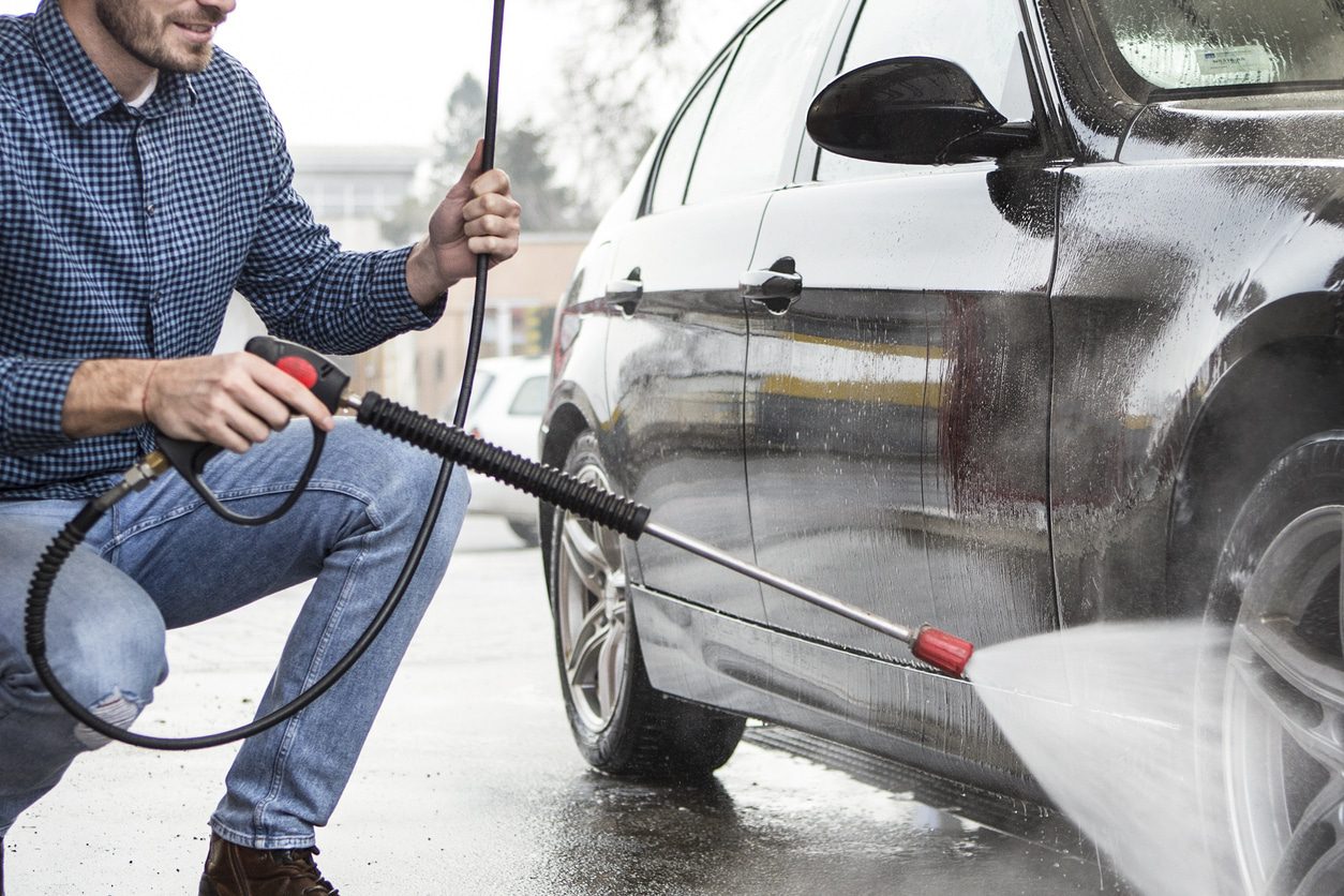photo of pressure washing a car’s lower panels