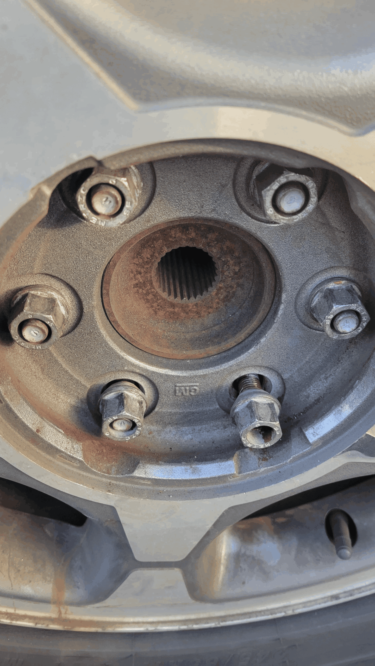 side by side photos of loose vs. properly tightened lug nuts. side by side photos of loose vs. properly tightened lug nuts.